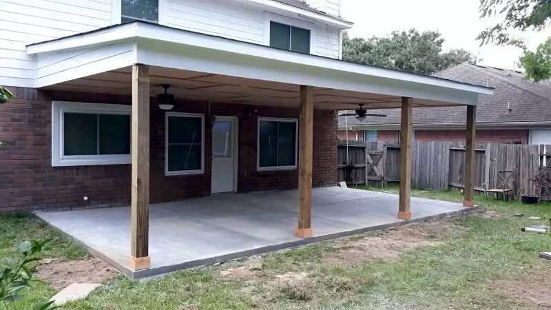 Same backyard with a new covered patio and concrete slab