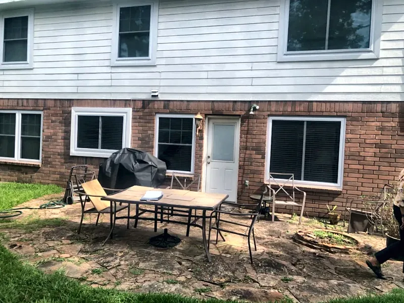 Backyard with an uncovered flagstone patio before the project